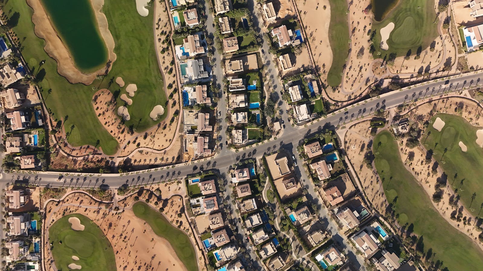 Discover the luxury homes and green golf courses in Sheikh Zayed, Egypt, captured from above.